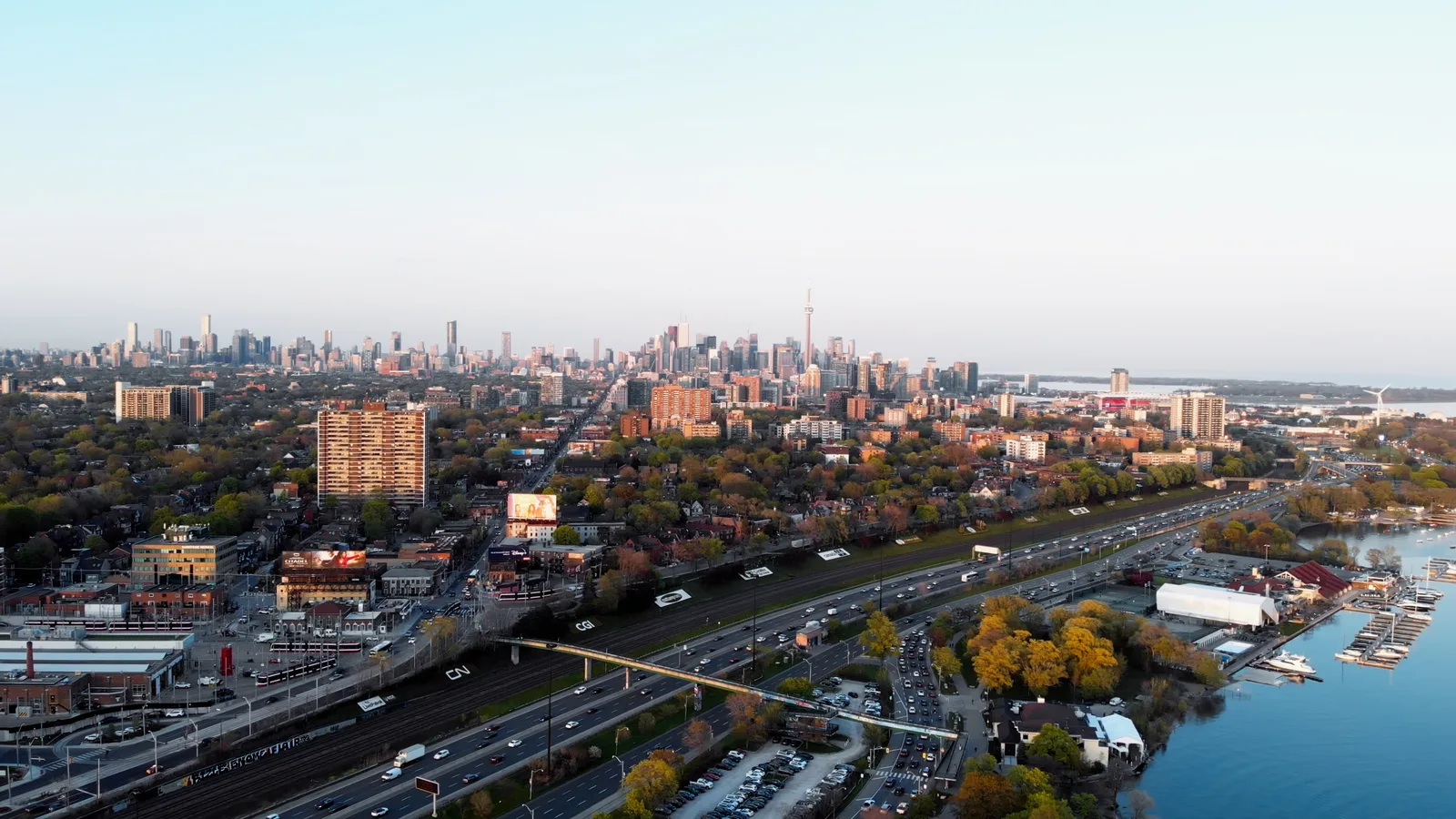 A panoramic aerial view of the Toronto skyline at sunset.