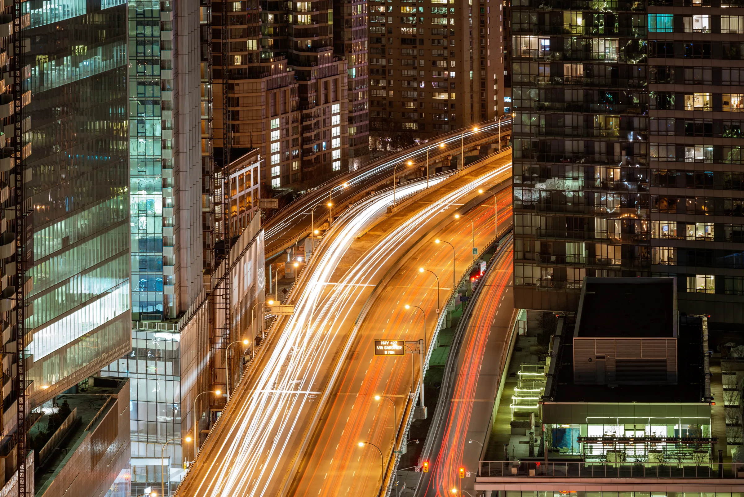 Night traffic streams through downtown Toronto.